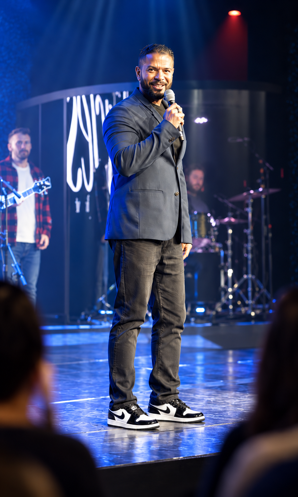 Jason Godinho speaking to a seated audience during an event.